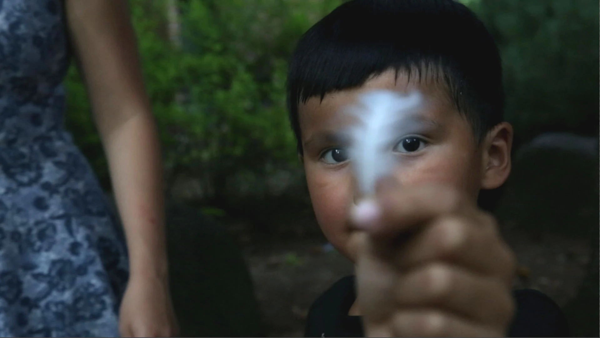 A child holding a feather during a Teach For Canada production